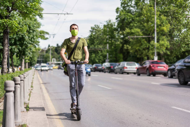 istock Man using electric scooter in the city 1280228387