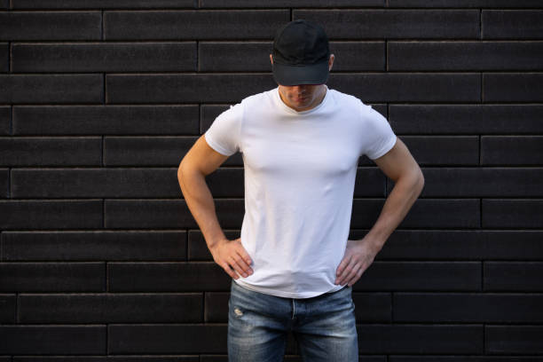 istock Man in white t-shirt standing against brick wall 1280228619