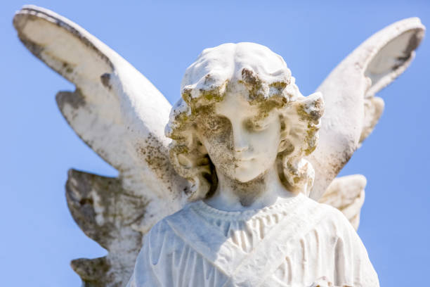 istock Angel, old statue of angle, blue sky background with copy space 1280229251