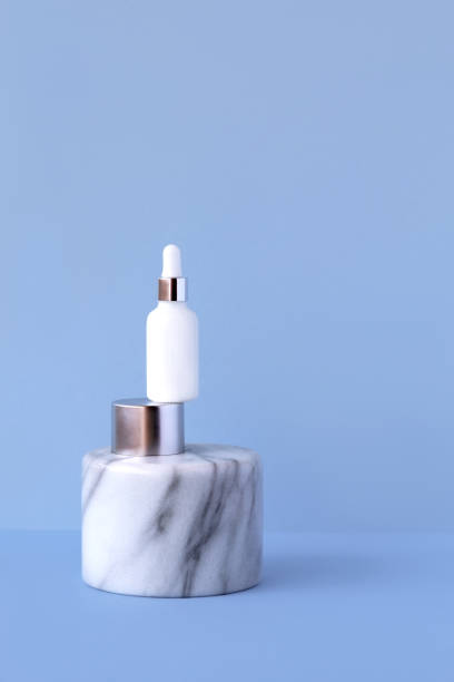 istock White glass bottle cosmetic serum cerulean background. 1280232821