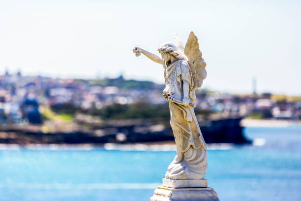 Old statue of angle standing over city in cemetery build in 1877 Sydney Australia, background with copy space, horizontal composition