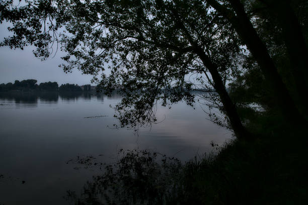 Ullíbarri-Gamboa Reservoir, Nanclares de Gamboa, Vitoria Gasteiz, Basque Country, Spain. Cloudy morning over the calm lake.