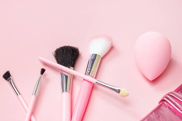 istock Top view of bright pink decorative cosmetics tools and accessories for professional make up and visage on light background with copy space 1280233722