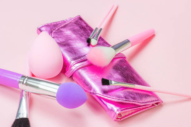 istock Bright pink decorative cosmetics tools and accessories for professional make up and visage on light background 1280233831