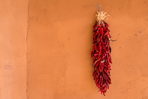 Dried chillies hanging in the sun on a street in Magome in Japan..