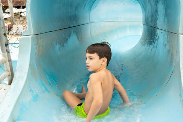 istock 6 year old boy ready to go down the toboggan run. 1280238278