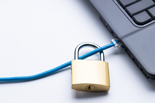 online security and network privacy conceptual. internet cable is locked by golden padlock.