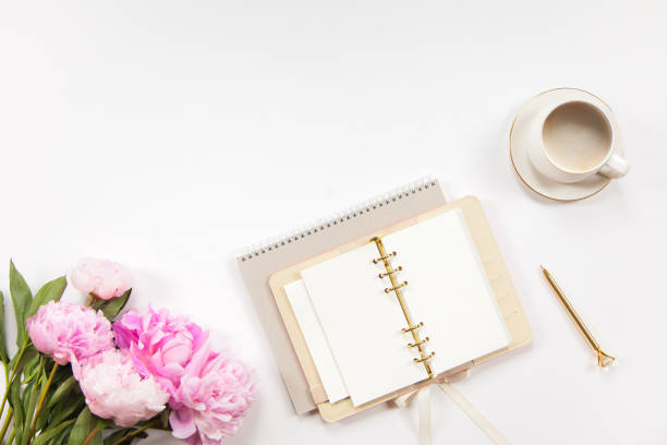 istock Notepad and beige leather covered diary with clean sheets, gold pen, cup of flat white coffee 1280240168