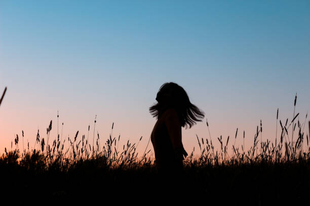 istock Girl dancing in a field at sunset 1280240283