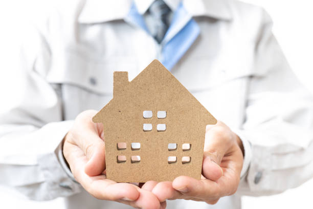 istock A businessman with a model of a house 1280242864