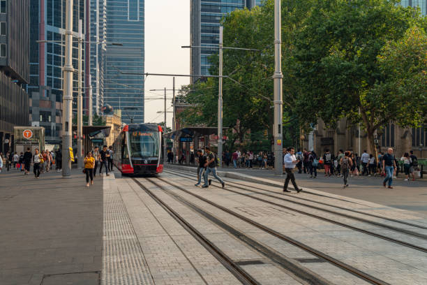 Tourists are walking on the street in front of the city hall, Sydney, Australia.