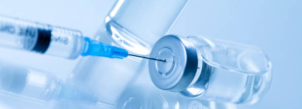 istock Medical syringe with a needle and a bollte with vaccine. 1280243660