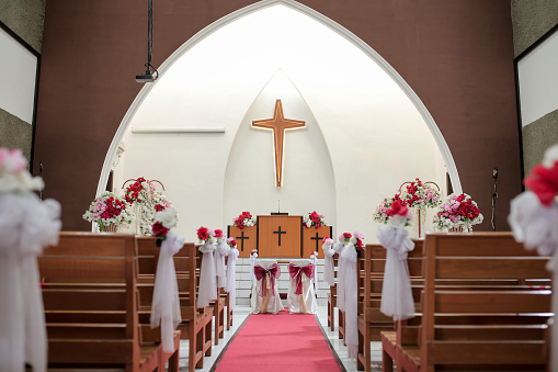 Church interior decorated for wedding marriage ceremony. Wedding decoration in the church.
