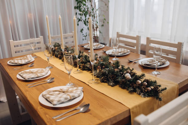 istock Beautiful Christmas serving table with candles and fir-tree decoration at cozy modern interior 1280243898