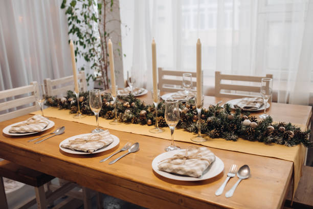 istock Beautiful Christmas serving table with candles and fir-tree decoration at cozy modern interior 1280243899