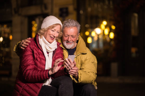 istock Man and woman sitting and using the phone 1280246956