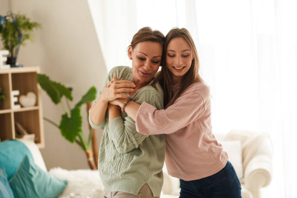 istock Young woman embracing her mother while they are dancing 1280247010