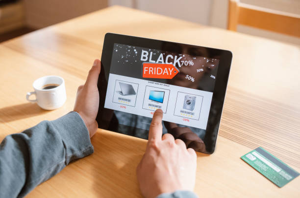 Woman shopping at Black Friday. Unrecognizable woman shopping at Black Friday, she using digital tablet and ordering electronics online. black friday stock pictures, royalty-free photos & images