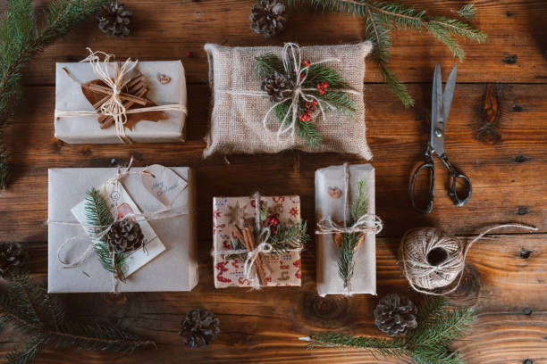 istock Wrapped Christmas presents on wooden table background. 1280247735
