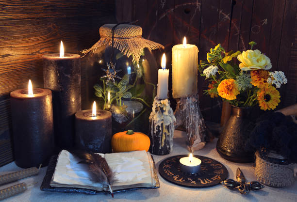 istock Mysterious still life with open diary book and black candles on witch table 1280249619