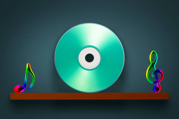 Blank music CD with multi colored Musical Note on a wooden shelf against dark blue wall with copy space.