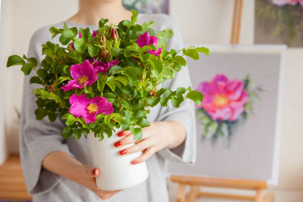 istock An unidentified blurry young woman holds a vase in her hands 1280262292