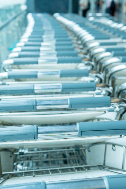 istock Rows of airport luggage trolley carts 1280263229