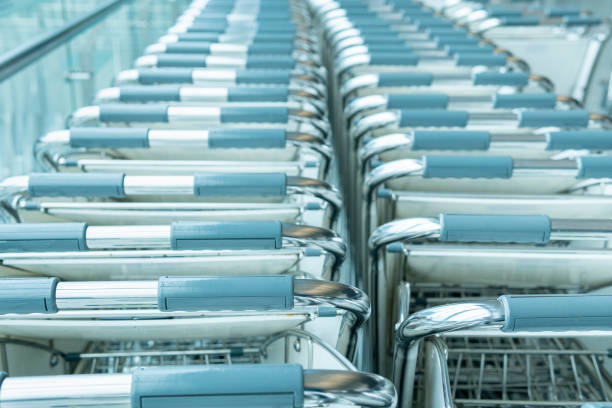 istock Rows of airport luggage trolley carts 1280263230
