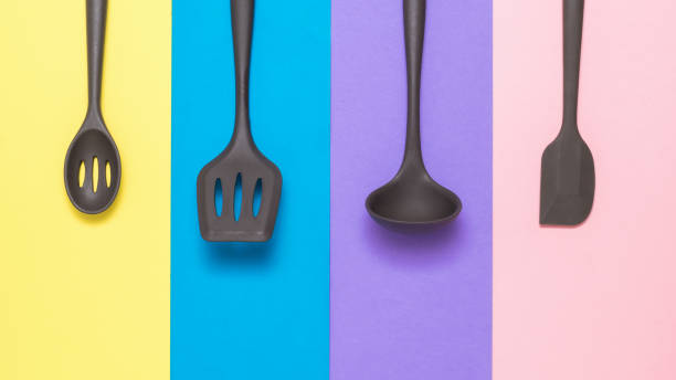 istock Four silicone kitchen accessories neatly stacked on a multi-colored background. 1280264056