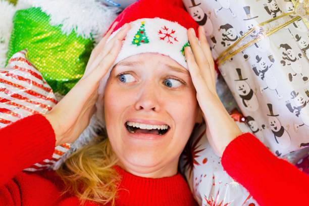 A woman worried and stressed out during the holiday season. Christmas gift shopping. stock photo