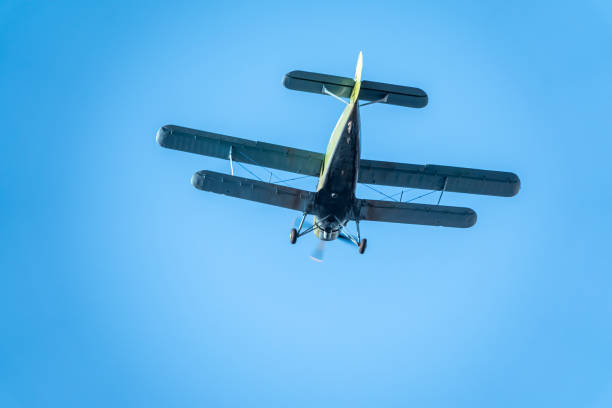istock Retro biplane plane in the blue sky 1280269381