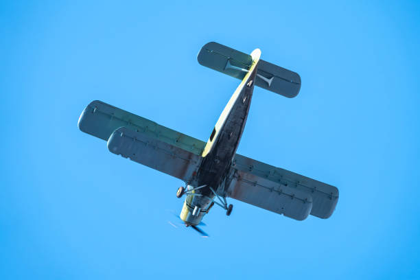 istock Retro biplane plane in the blue sky 1280269419