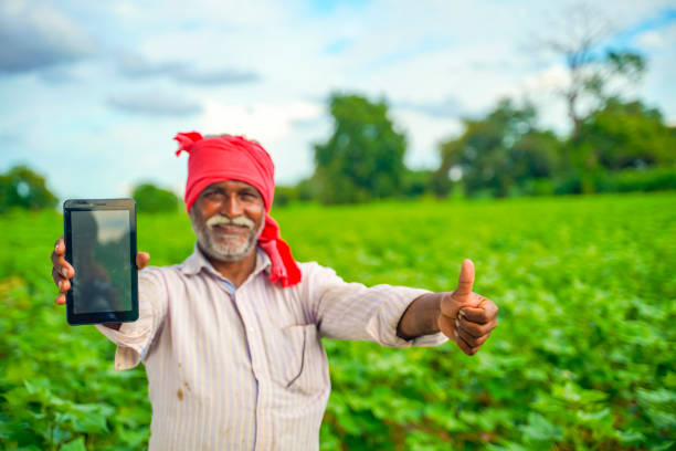 istock Indian farmer Showing a mobile screen at agriculture field 1280270576