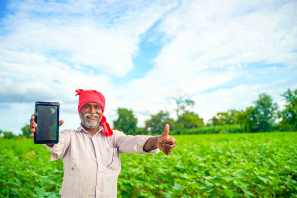 istock Indian farmer Showing a mobile screen at agriculture field 1280271100
