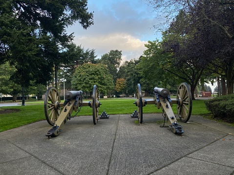 A historic cannon and the George Washington memorial statue in Washington Crossing Park in Bucks County Pennsylvania.