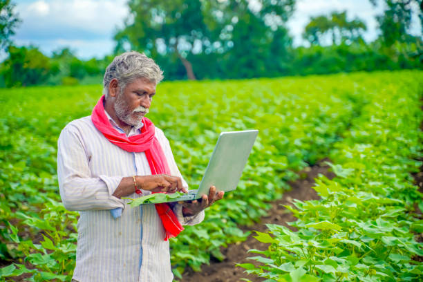 istock Indian farmer using a laptop at agriculture field 1280272291
