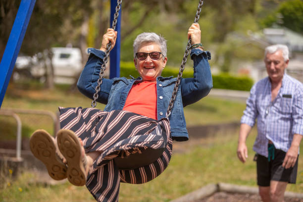 istock Active Senior Couple Playing on a Swing in the Park 1280273104