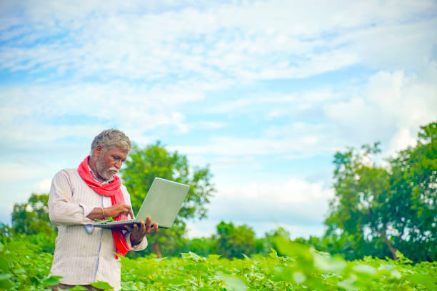 istock Indian farmer using a laptop at agriculture field 1280273116