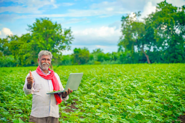 istock Indian farmer using a laptop at agriculture field 1280273194