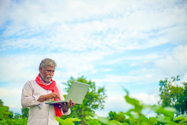istock Indian farmer using a laptop at agriculture field 1280273199