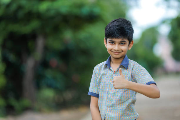 indian school boy showing thumb up