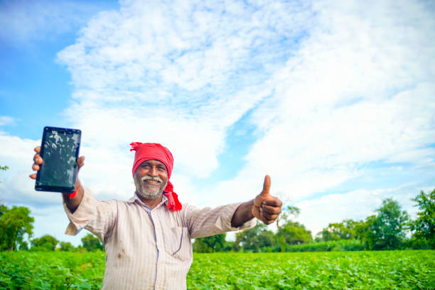 istock Indian farmer Showing a mobile screen at agriculture field 1280273899
