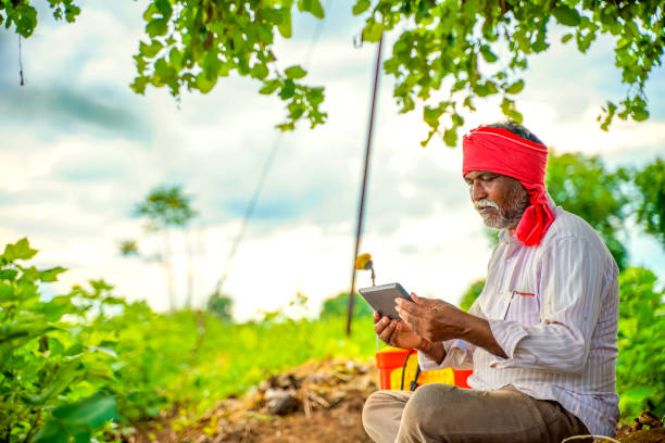 istock Indian farmer using mobile phone at Agriculture field 1280274760