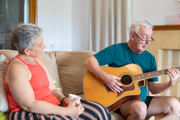 istock Senior Man Playing Guitar to His Wife 1280274967