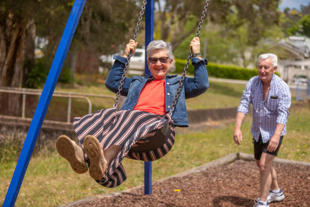 istock Active Senior Couple Playing on a Swing in the Park 1280275063