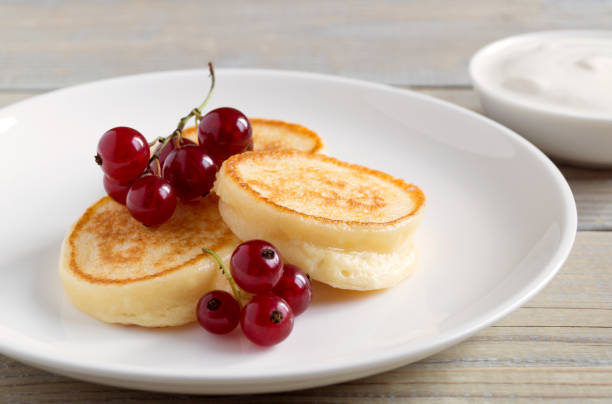 istock Cottage cheese pancakes, syrniki with fresh berries. 1280275984