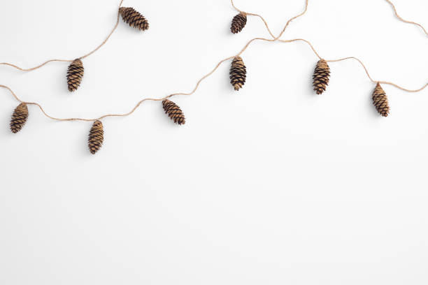 istock Zero waste christmas garland made from pine cone and natural jute twine. Horizontal composition, flat lay, top view. Eco friendly minimal christmas top mockup. 1280277008
