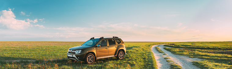Gomel, Belarus - May 6, 2020: Renault Duster SUV Parked Near Countryside Road In Spring Field Countryside Landscape. Duster Produced Jointly By French Manufacturer Renault And Its Romanian Subsidiary Dacia