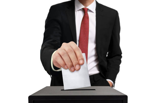 istock Man casting his vote into ballot box in close up 1280278903