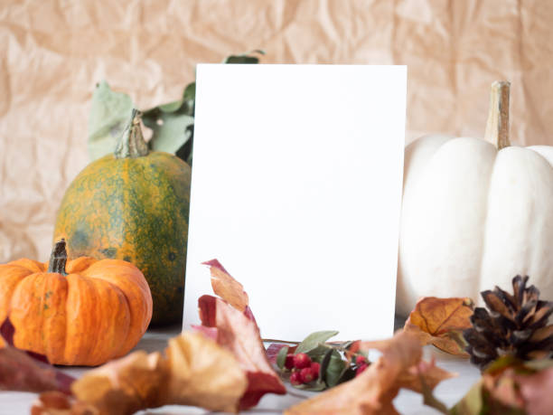 istock White paper on autumn background with decorative pumpkins 1280278974